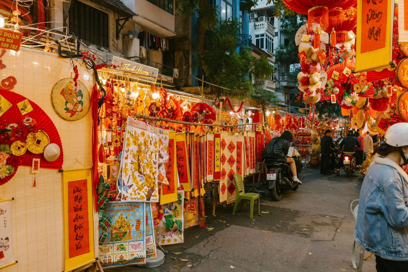 A Hanoi street stall overflows with red and gold Lunar New Year decorations ahead of Tet festivities.